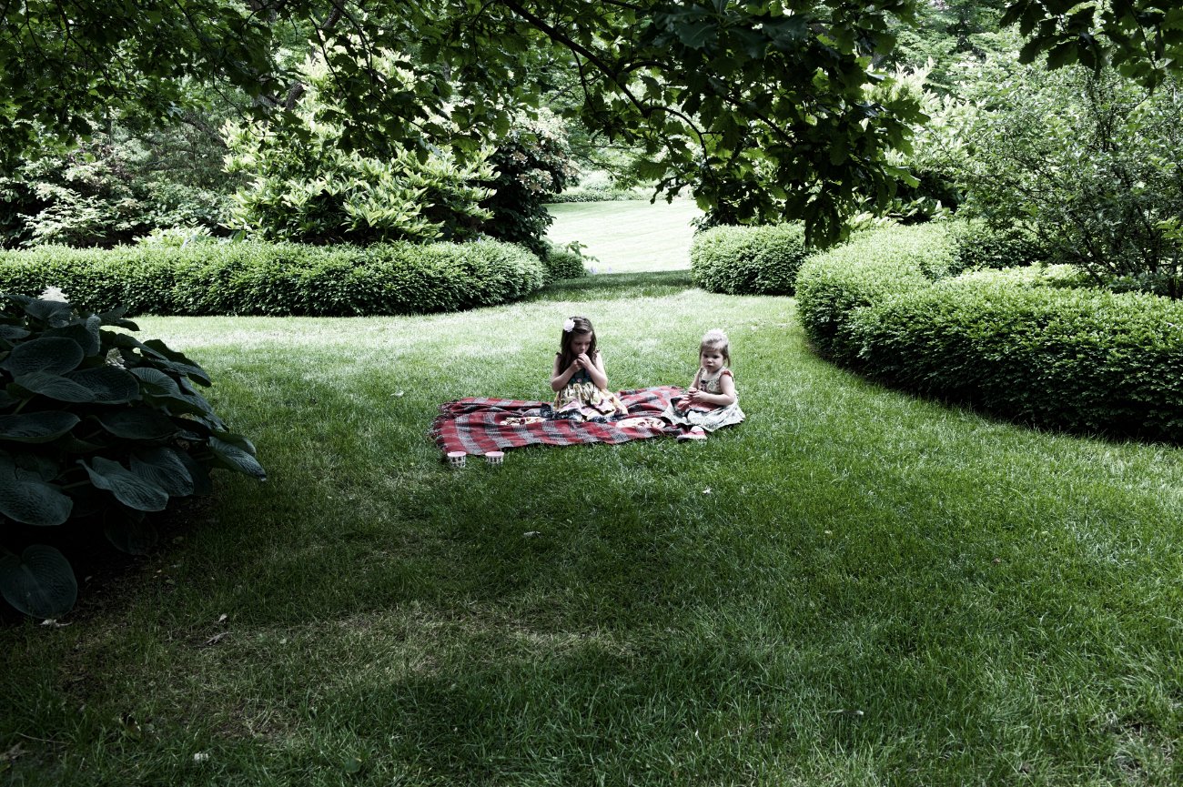 Peterson Children Portraits in Wisconsin - girls picnicing in the garden