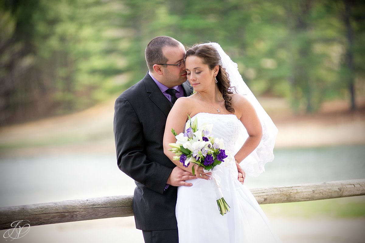 romantic photo of bride and groom in front of water