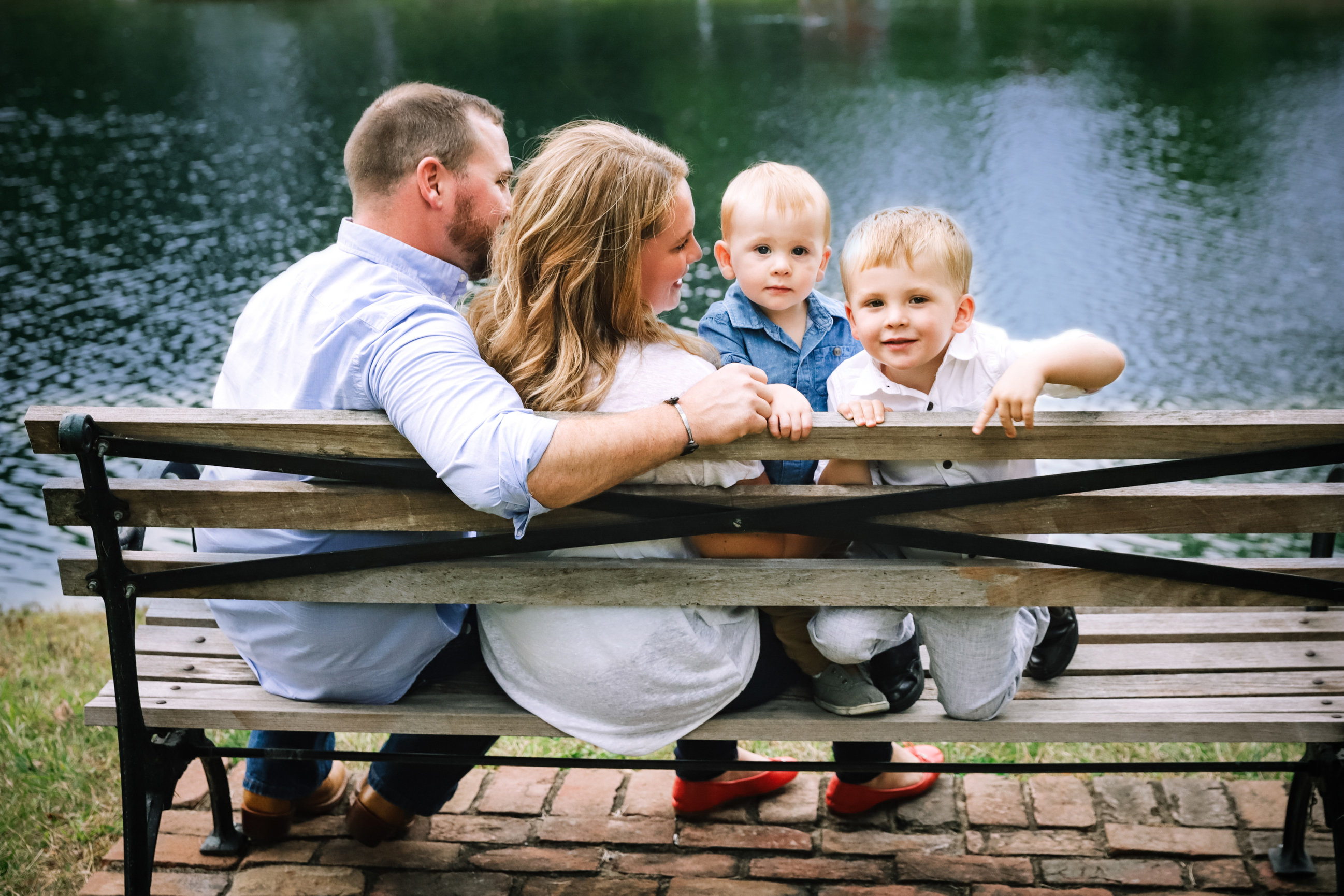 family of four at park overlooking water