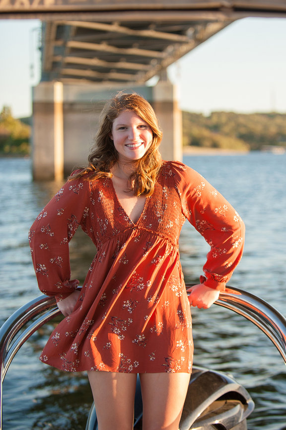 Senior girl in orange dress on a boat at Branson Missouri. 