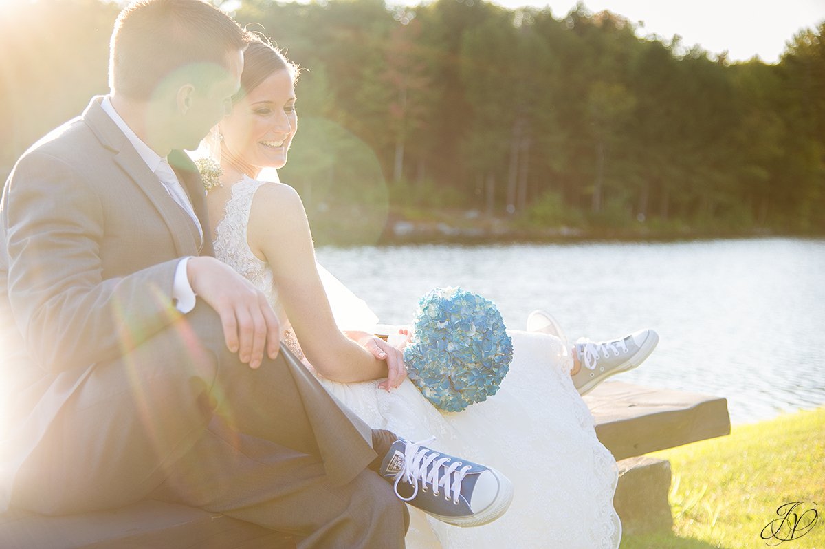 unique image of bride and groom on lake during sunset