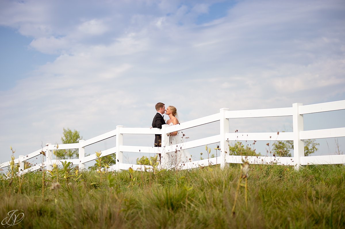 bride and groom white fence saratoga national