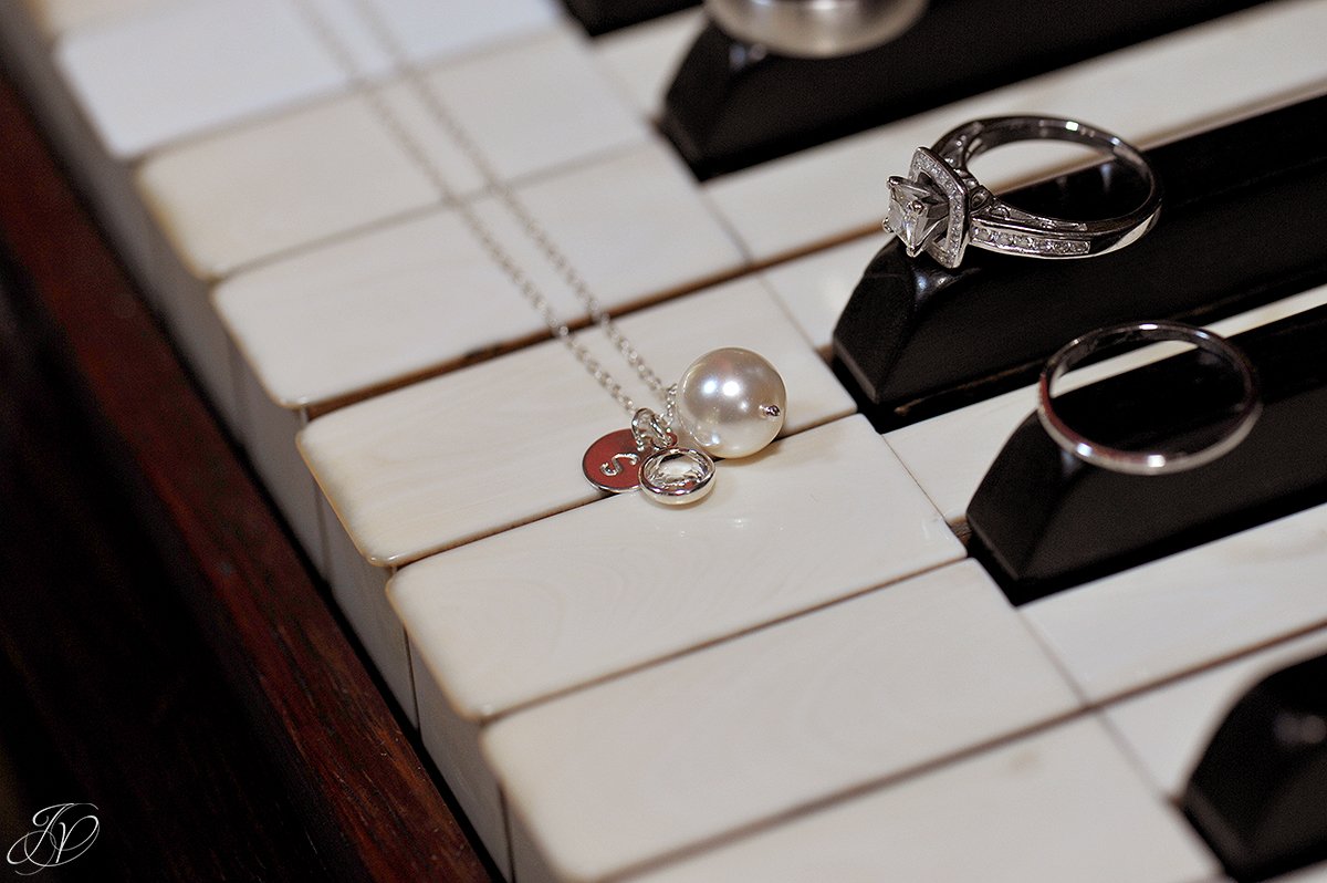photo of wedding jewelry on piano