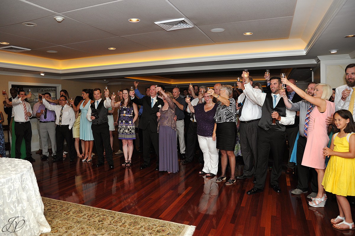 guests toast bride and groom during wedding reception