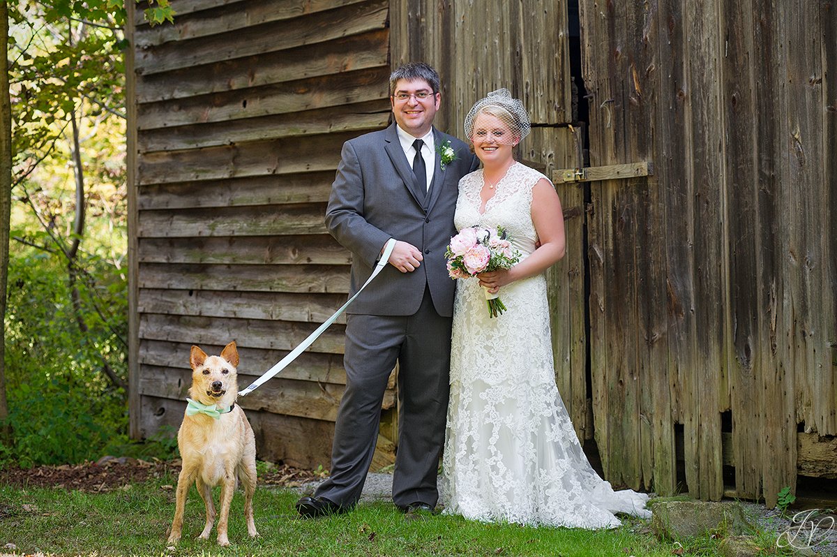 cute shot of bride and groom with their dog