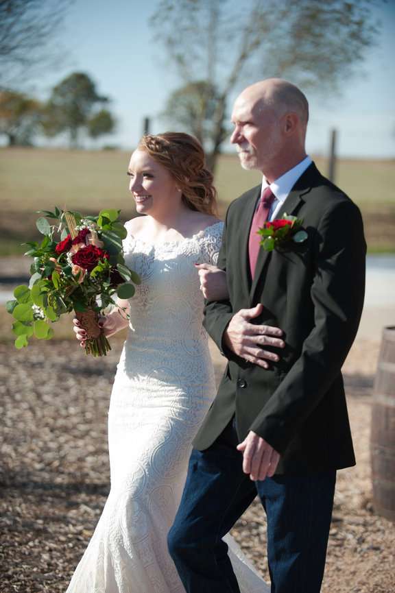Father escorting his daughter down the aisle to be married.