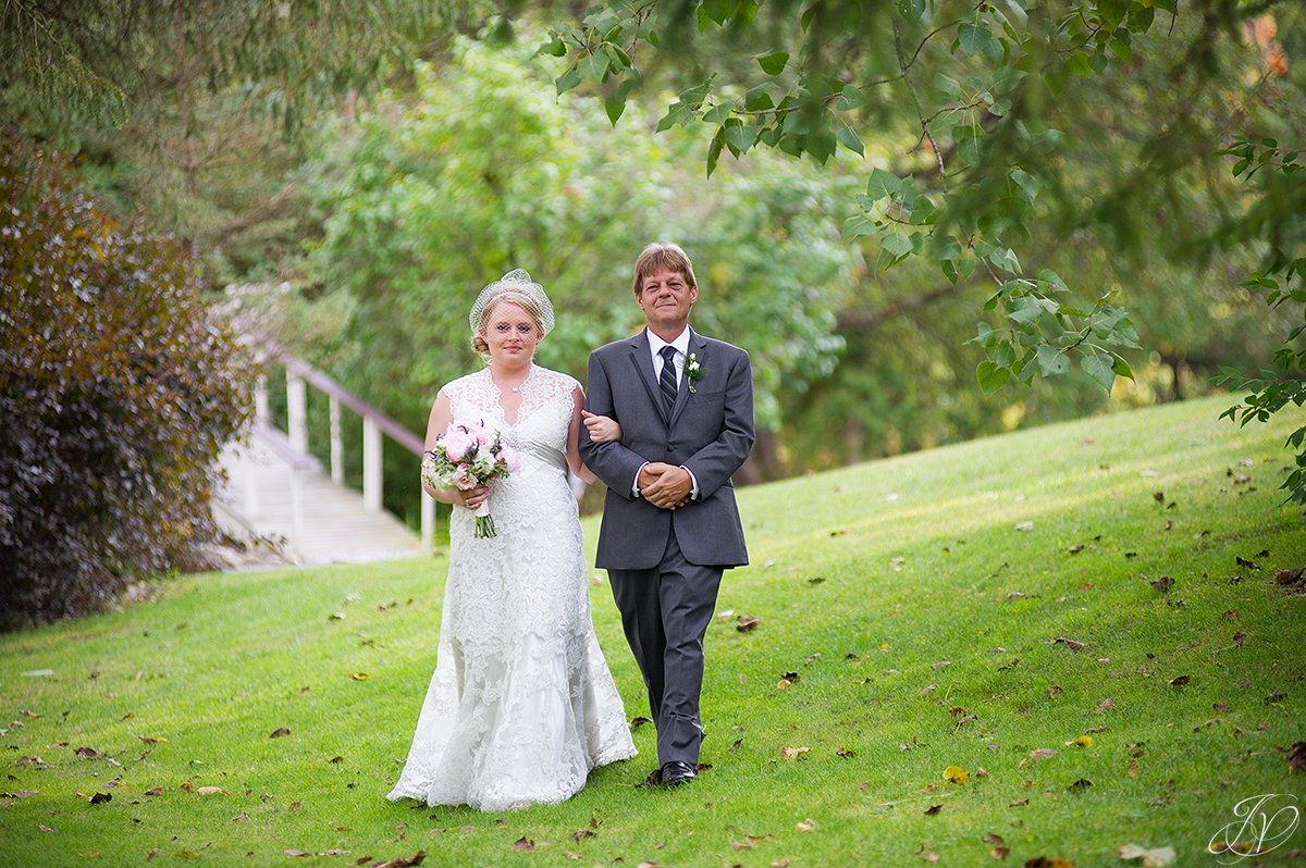 beautiful photo of bride and father walking down aisle