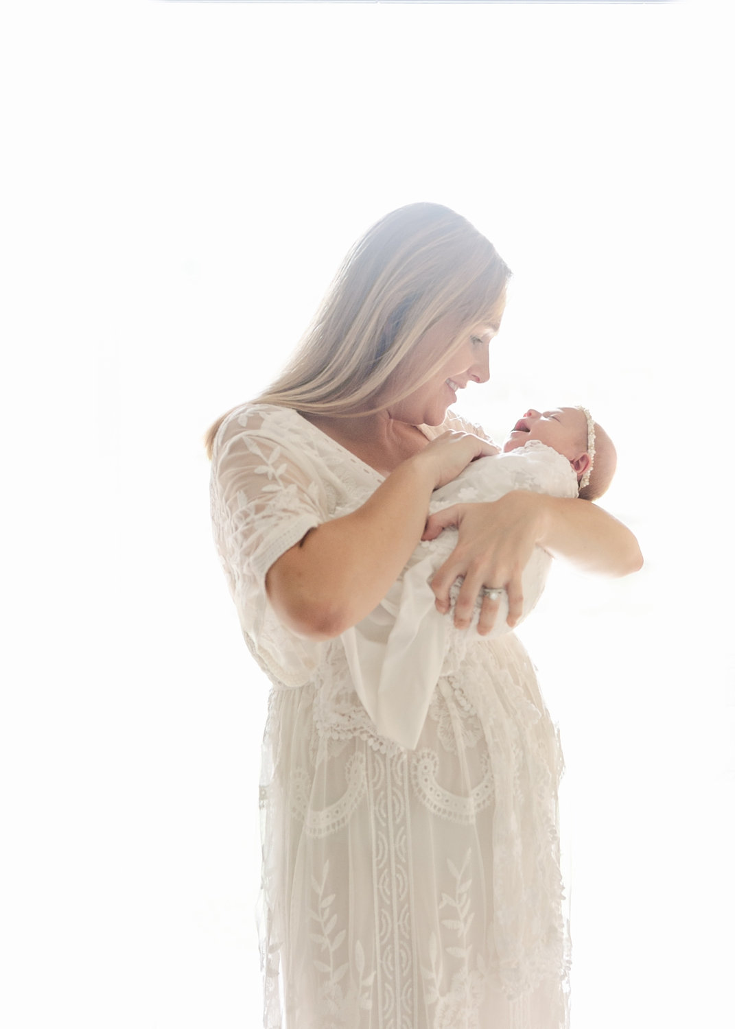 window lit portrait of mom and newborn daughter, Ryaphotos, St. Augustine