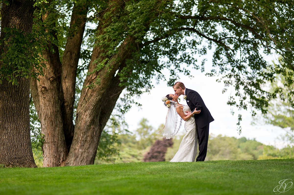 groom dipping bride outside normanside country club