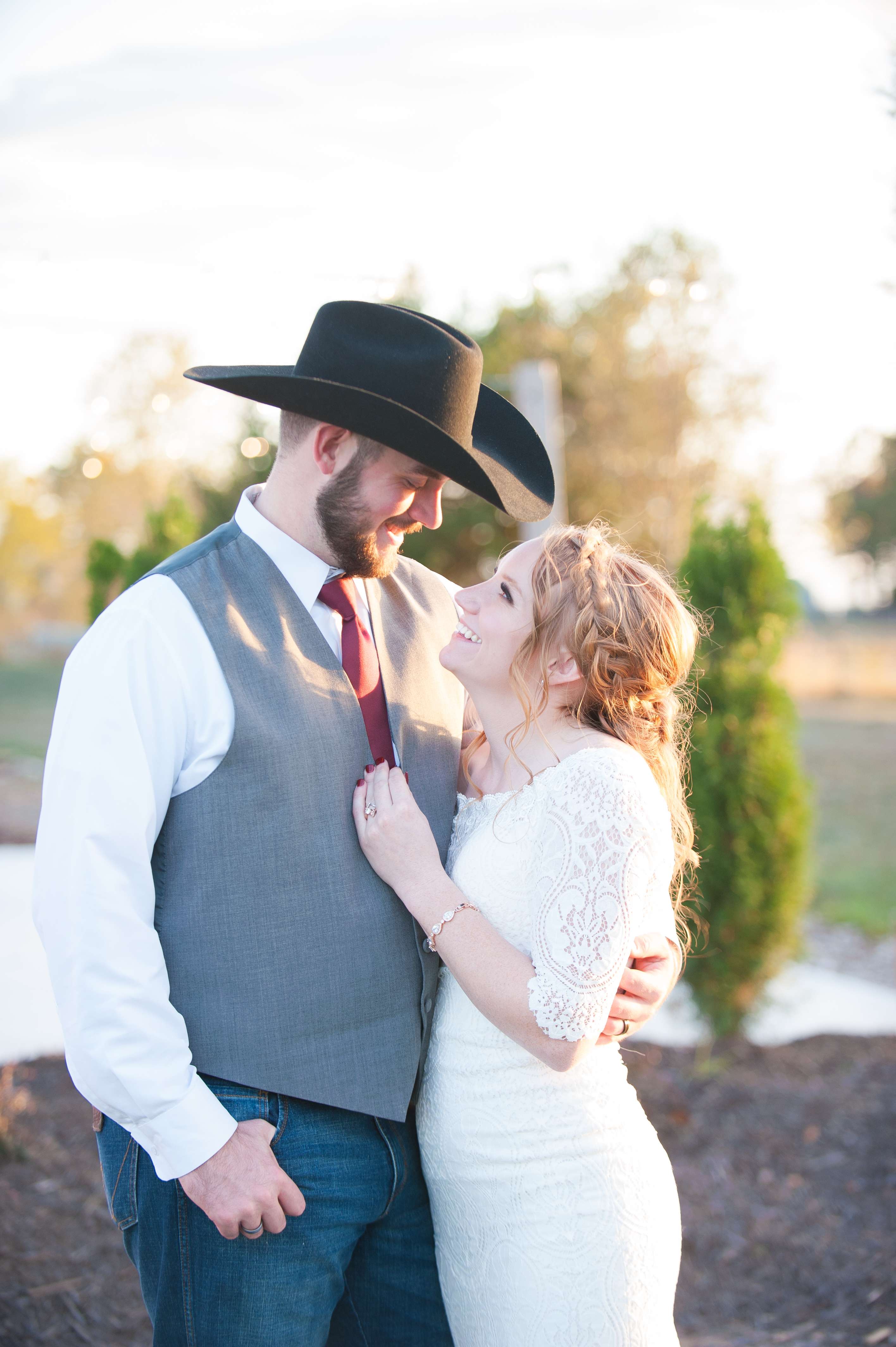 Bride and groom hugging at sunset after wedding ceremony near Springfield, Missouri..