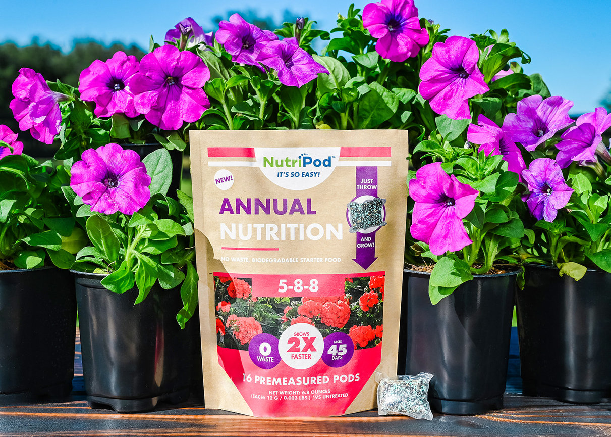 NutriPod Annual Nutrition plant food package with purple petunias. Eco-friendly, fast-acting starter fertilizer for flowers.