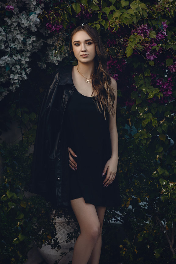 Stylish and fashionable photography portrait taken outdoors in short black dress and leather jacket. Professional picture taken by Adam Trujillo, a Las Vegas studio portrait photographer.