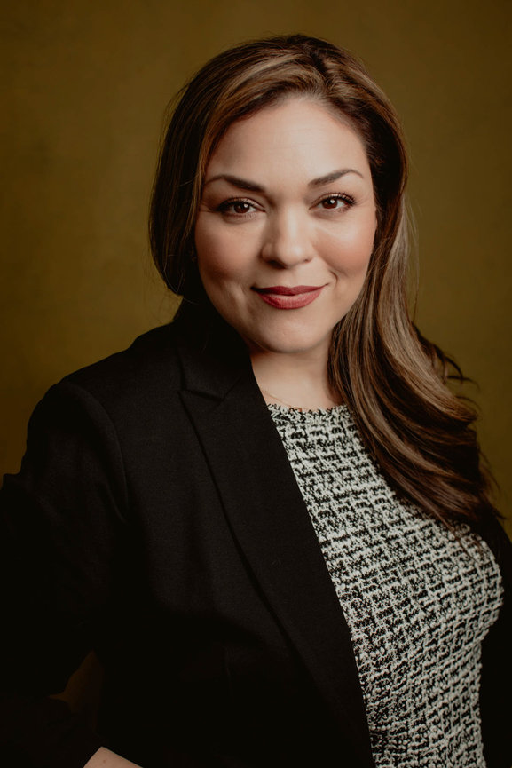Elegant portrait headshot with black sport coat and knitted blouse of Vegas professional makeup artist, taken in a photo studio with Adam Trujillo, a Las Vegas portrait photographer.