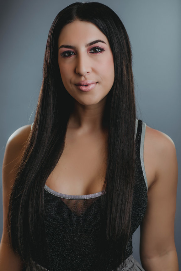 Professional business casual headshot in studio with blue gray backdrop and studio lighting. Professional headshots and team portraits in studio with Adam Trujillo.