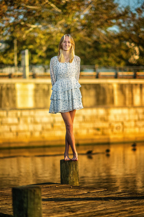 Senior girl in flowing dress at golden hour over water — fine art waterfront senior portrait, Katy ISD senior photographer Swartz Portraits Katy Texas