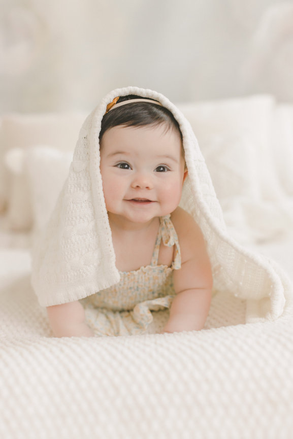 Baby under blanket