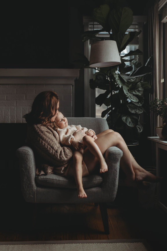 A woman sitting on a chair with her daughter on her lap in Morris County, New Jersey.