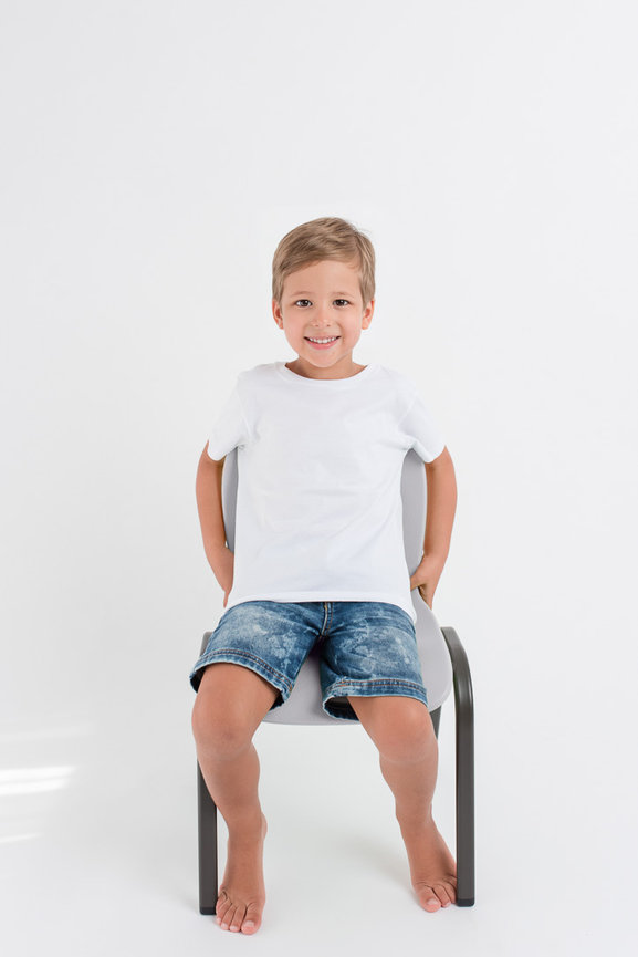 picture of a young boy sitting on a chair photographed in a studio
