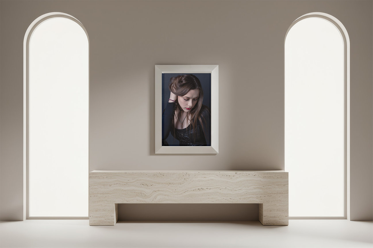 framed portrait artwork centered on wall above stone bench in a minimal home interior