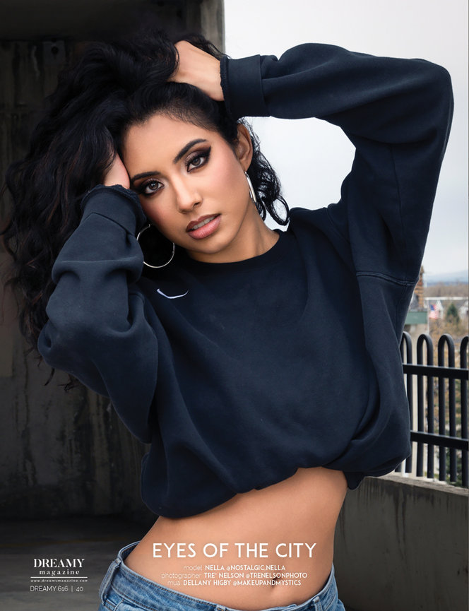 Model Nella striking a confident pose in a cropped black sweatshirt with bold makeup, featured in Dreamy Magazine. Professional editorial and personal branding photography by Tre Nelson Photo. Perfect for showcasing style and empowerment.