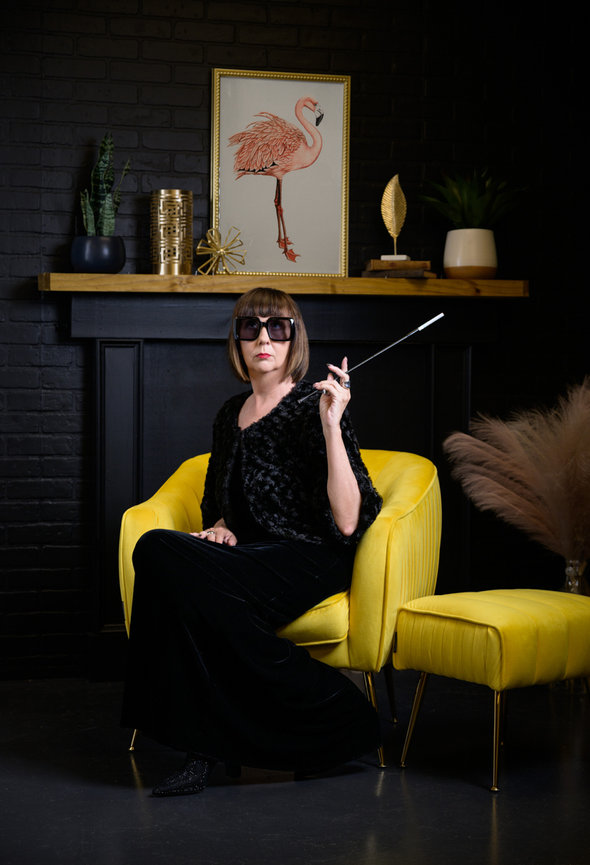 Studio portrait experience for women Orlando - woman in black outfit with oversized sunglasses and cigarette holder seated in yellow velvet chair, She's More Than by Karen K Photo