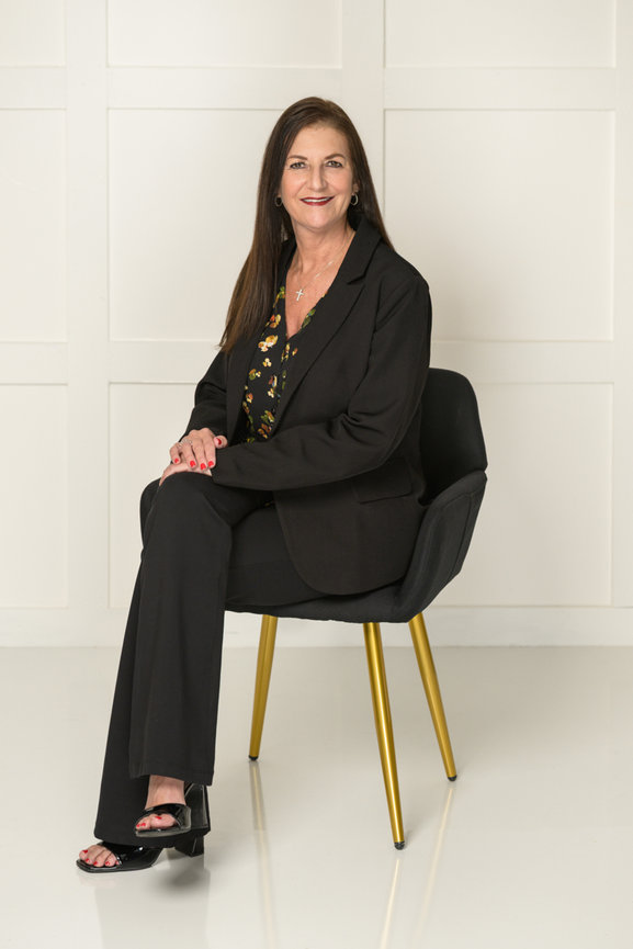Professional women's portrait photography Orlando - woman in black blazer and floral top seated in black velvet chair with gold legs, She's More Than by Karen K Photo