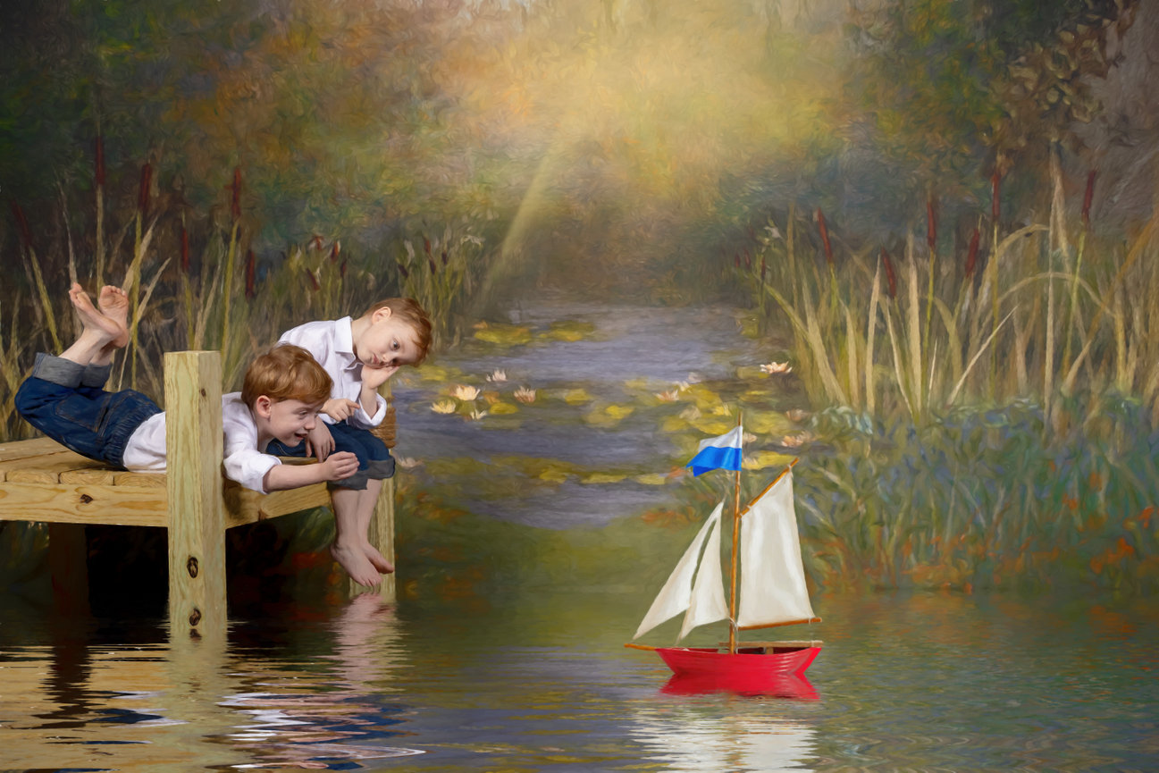 Whimsical fine-art portrait of two young boys on a wooden dock, watching a red toy sailboat drift through a hand-painted lily pond scene with golden light.