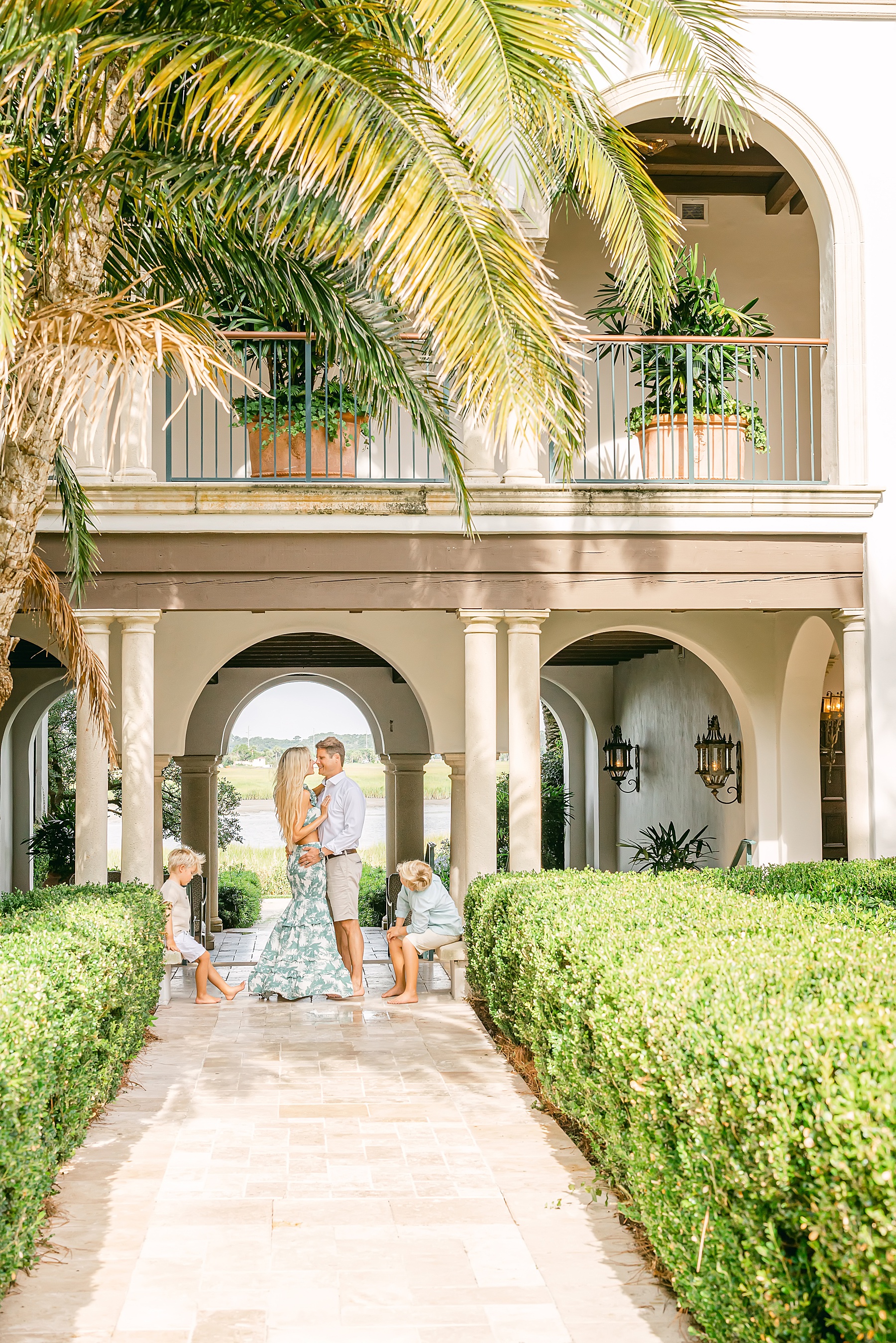 family standing under archway at the cloister sea island