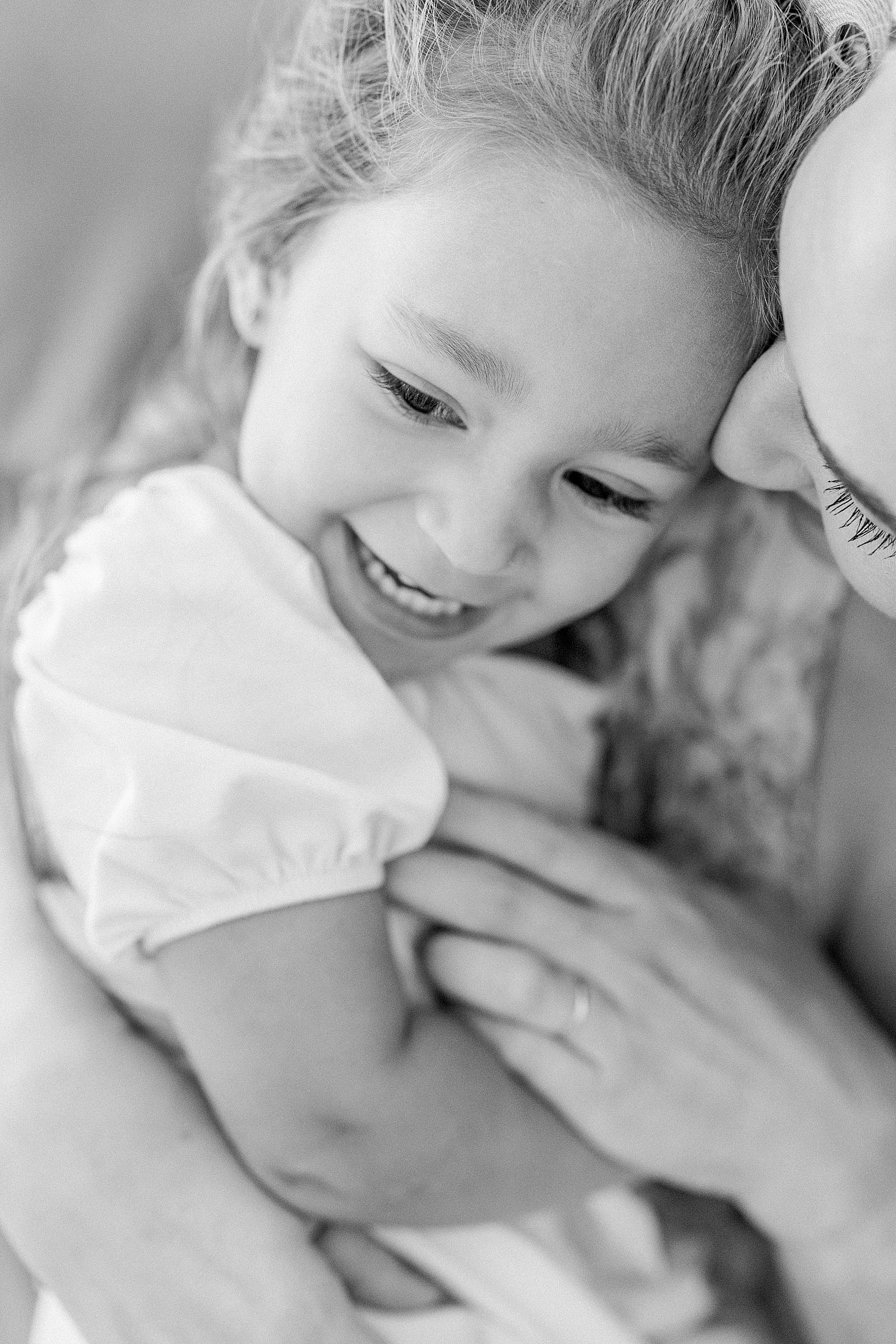 black and white portrait of baby girl with mother in white dress