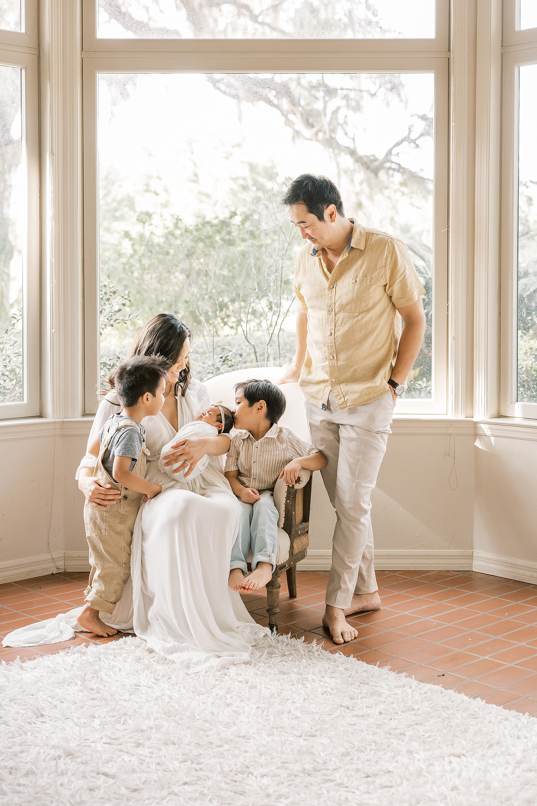 family of five welcoming newborn baby girl in their neutral home in Alachua Florida