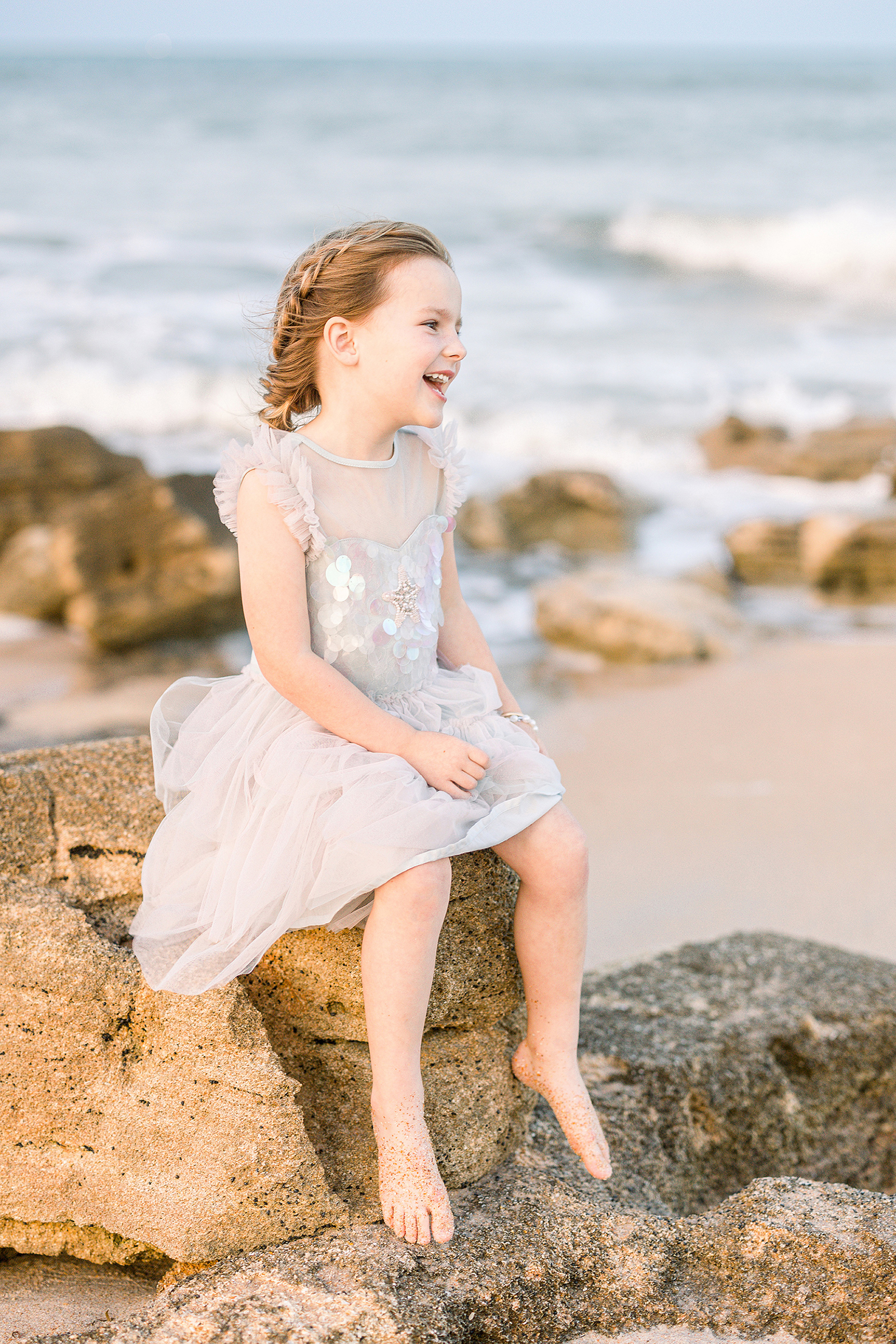 little brown haired girl in a mermaid tulle dress on Saint Augustine Beach