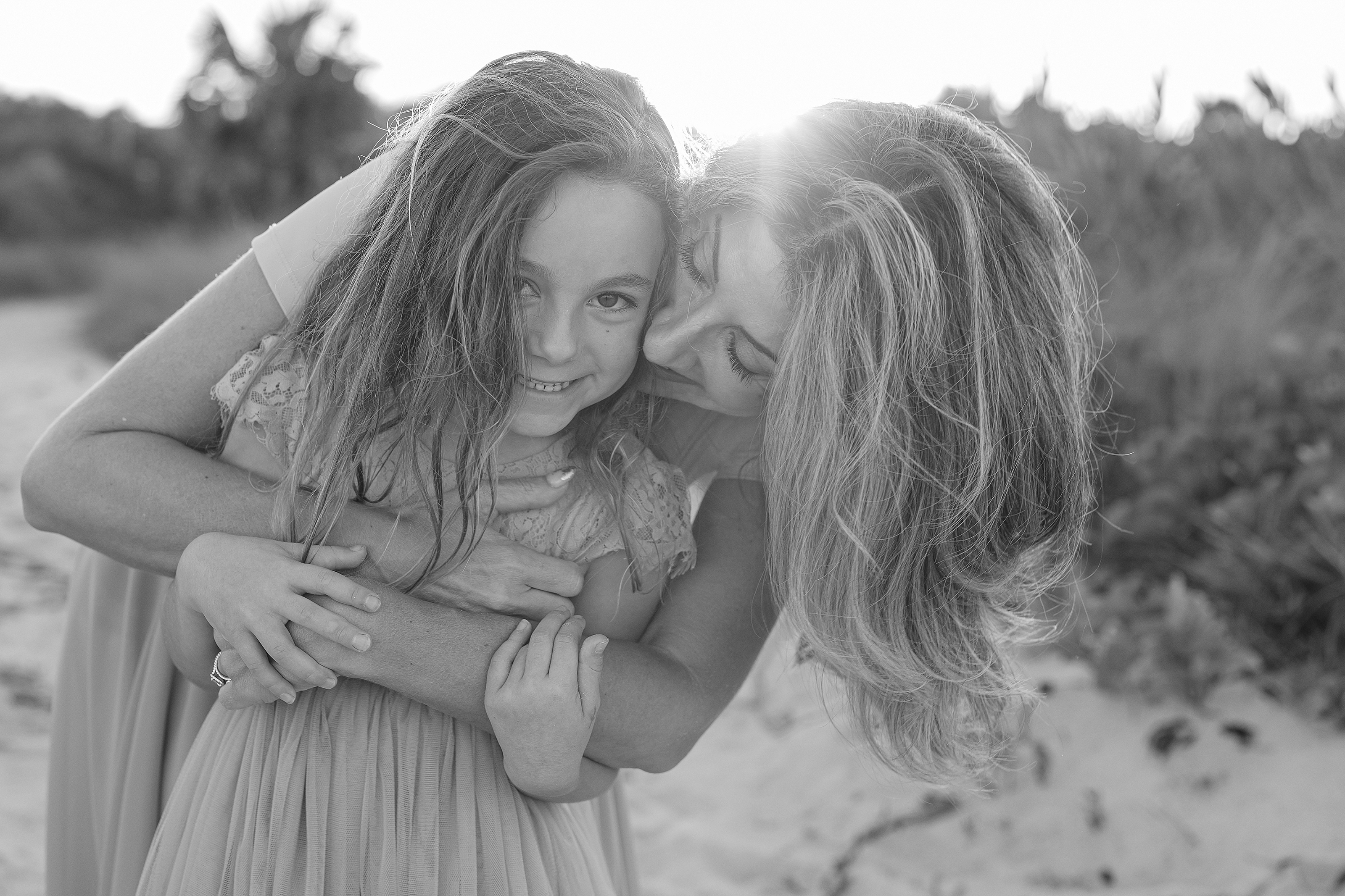 Black and white beach portrait a mother and daughter.