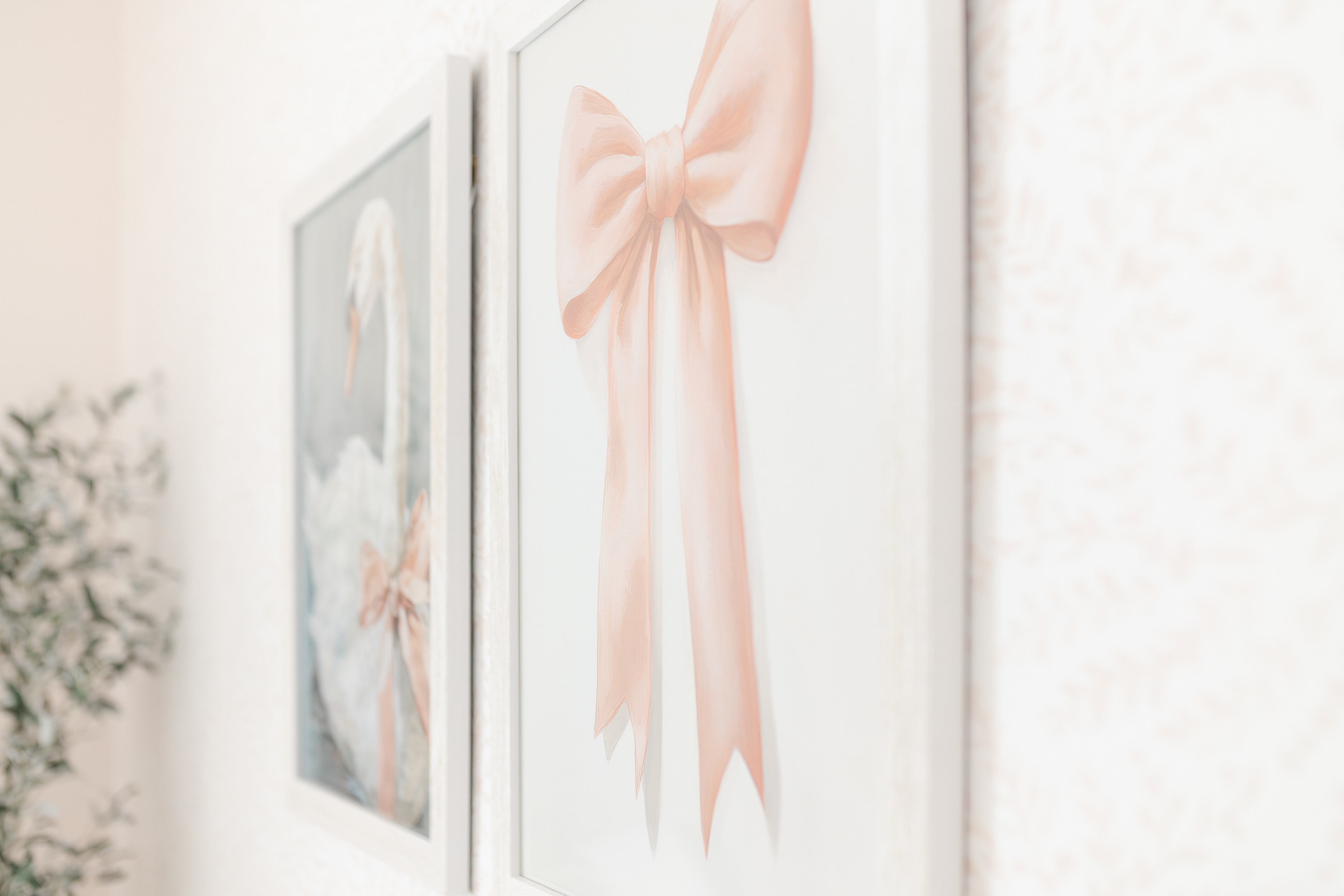 A detail shot of a pink and white baby girl nursery with bows.
