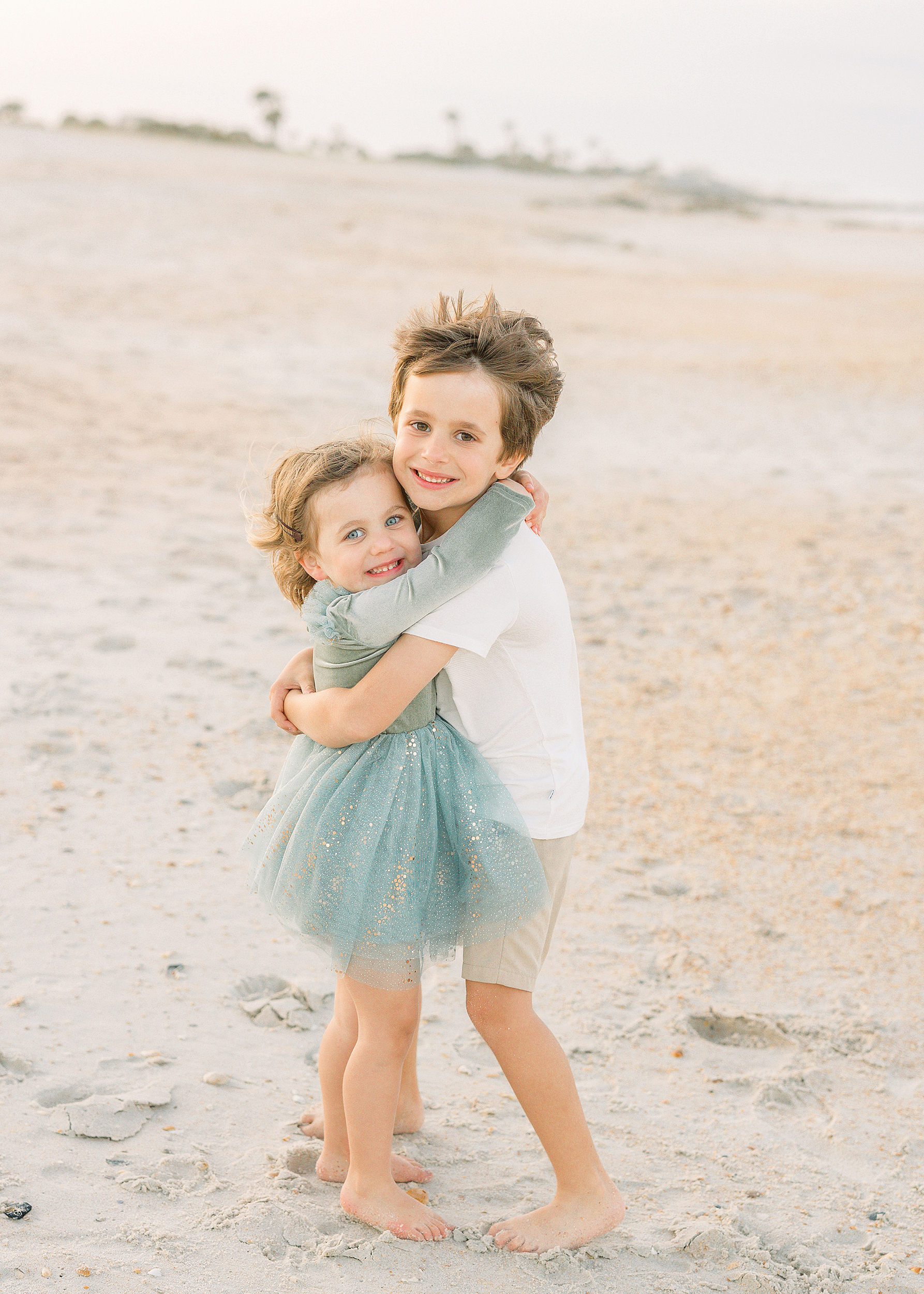 A pastel light and airy family beach portrait.