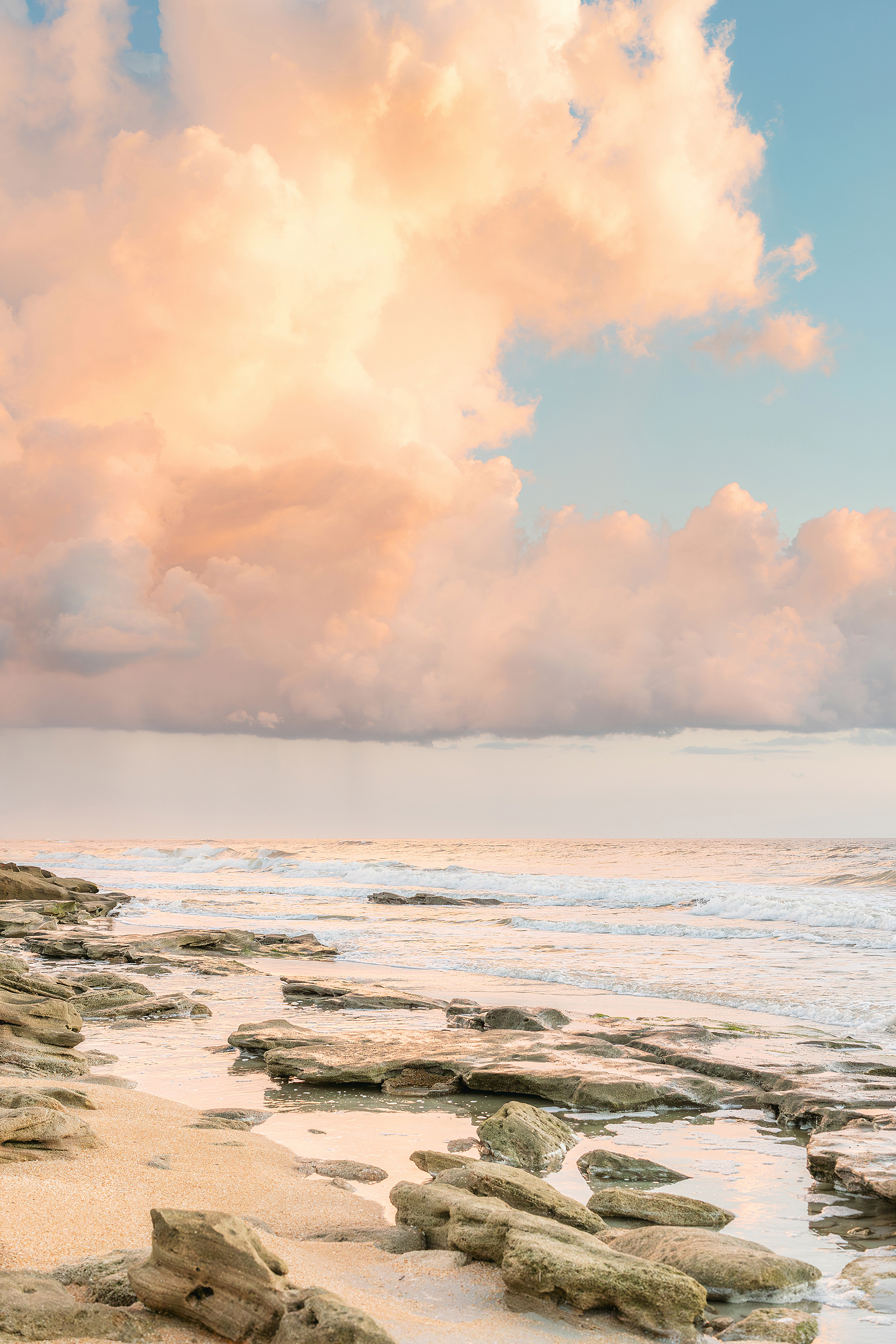 A pastel landscape portrait of a Saint Augustine Beach at sunrise.