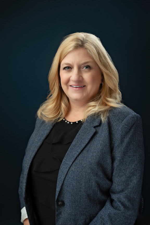 Headshot in studio on a blue backdrop, Onalaska Wisconsin branding and headshot photographer