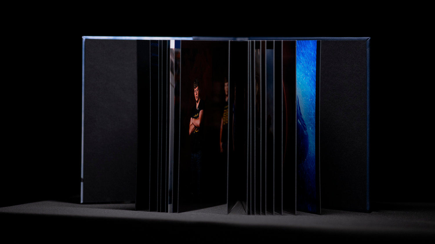 Open book with colorful pages displayed against a dark background.