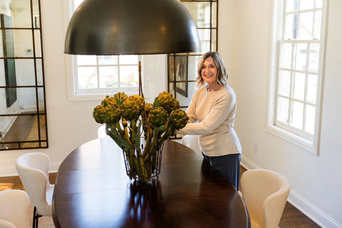 Spaces Done Right founder portrait arranging flowers in a dining room, branding photography New Albany Ohio