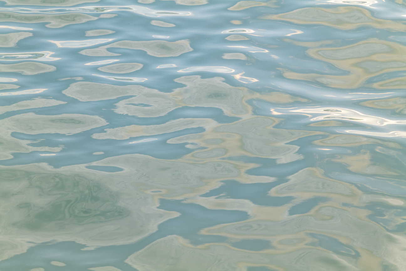 Liquid Light I - abstract ocean photography by Andrea Bruns showing soft reflections and luminous water patterns on the Pacific surface.