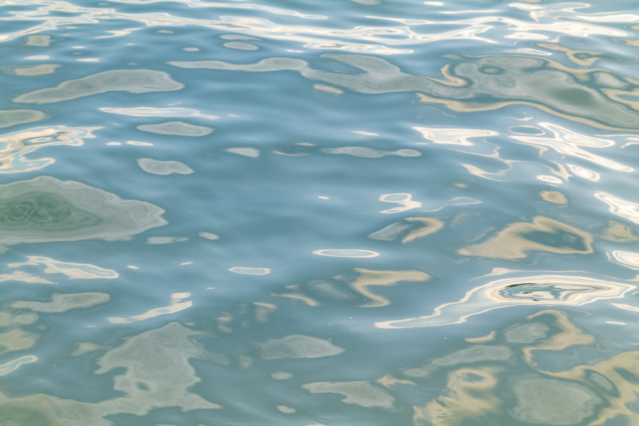 Liquid Light II - abstract minimalist ocean photograph by Andrea Bruns capturing flowing reflections and soft turquoise water light.