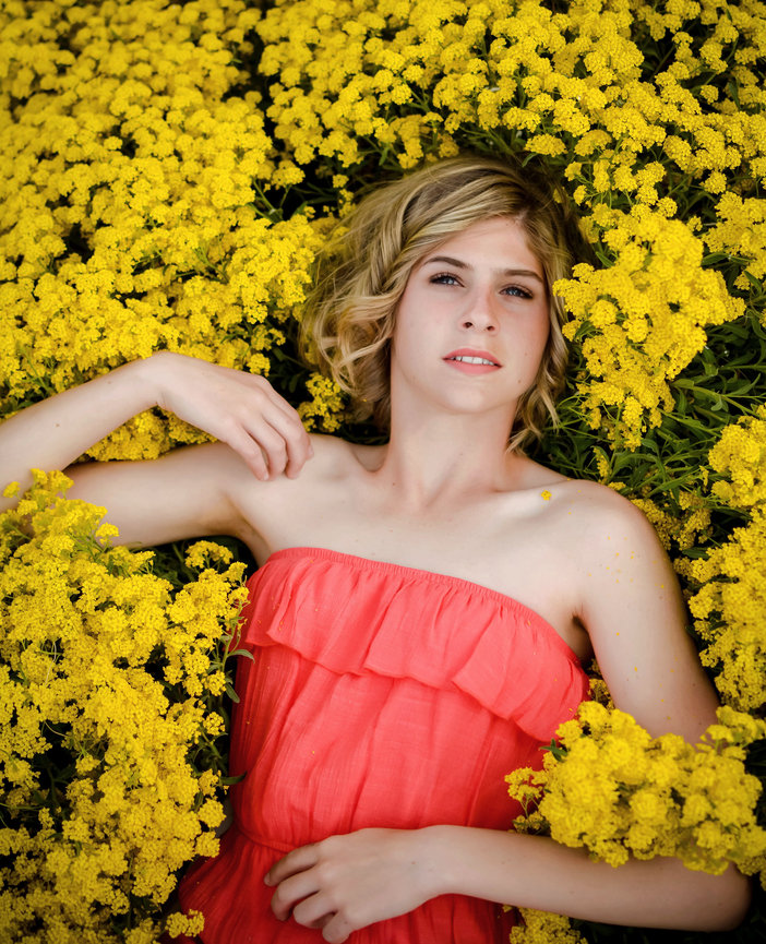 Senior year girl laying in flowers in spring. Meridian, Idaho