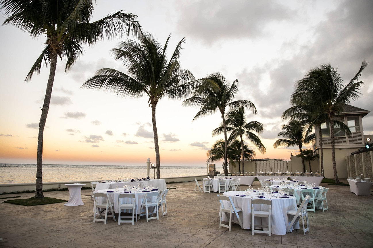 A curated waterfront reception setup on the Bermuda coast; featuring the clean lines of island architecture and the effortless elegance of a destination celebration.