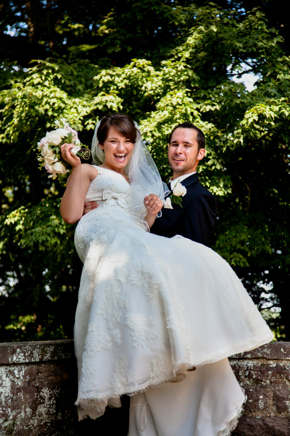 Groom holding bride in a playful pose