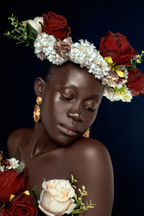 Woman with floral crown looking down