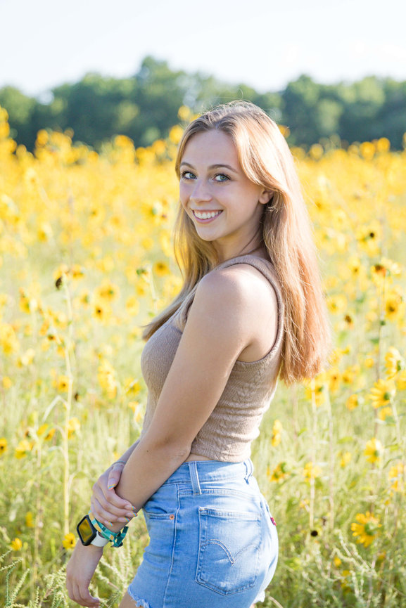 Woman standing in a field of sunflowers