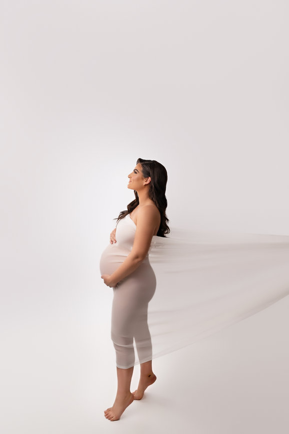 Close-up maternity image highlighting baby bump with sheer fabric wrap, Little Silver NJ