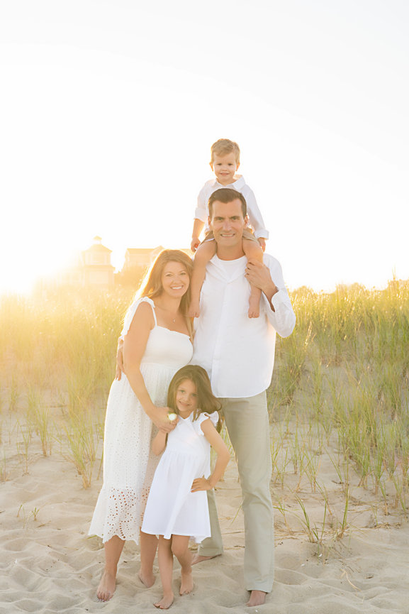 Modern family beach portrait with clean, white wardrobe styling