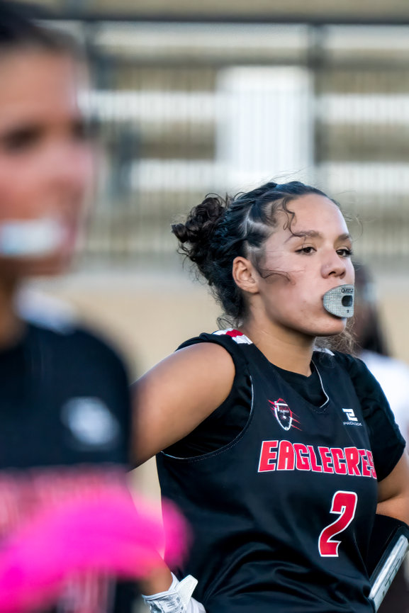 Female athlete shouting on the field during a flag football game.