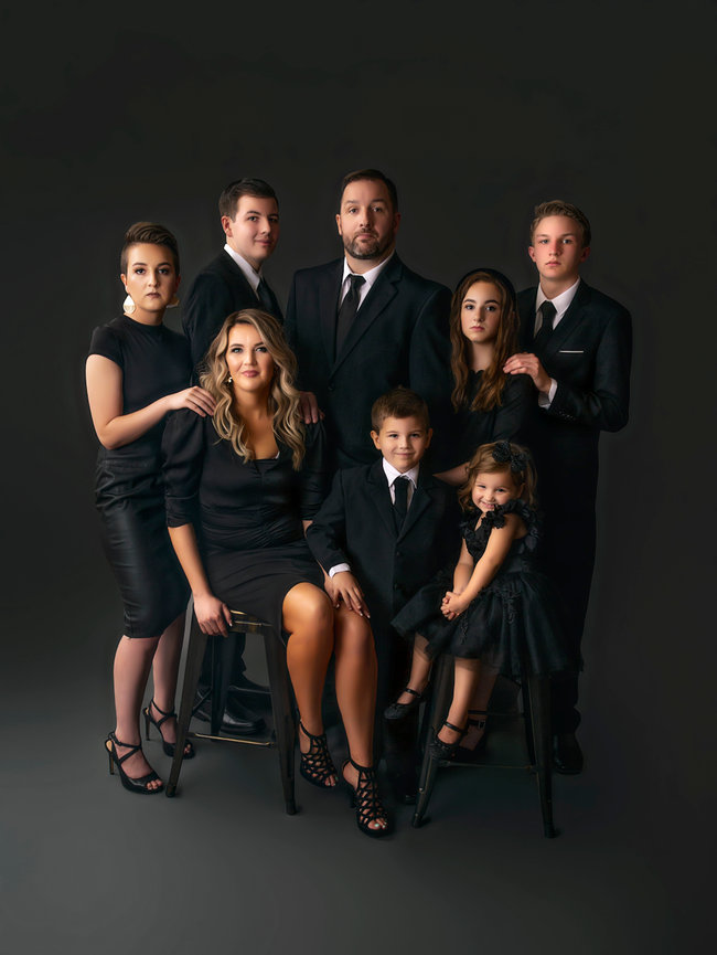 Formal family portrait session in Fort Worth studio with group in black outfits.