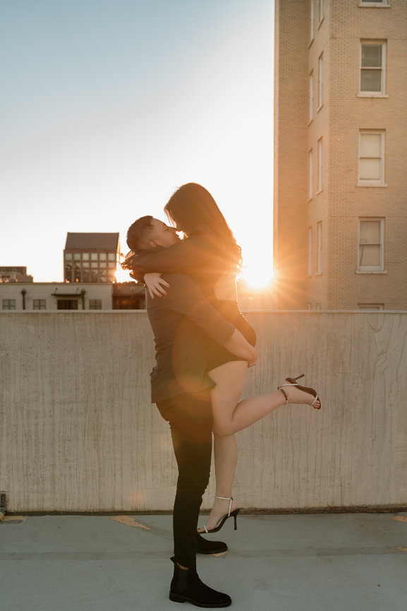 Couple embracing at sunset on a rooftop